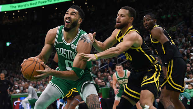 Jayson Tatum is guarded by Stephen Curry